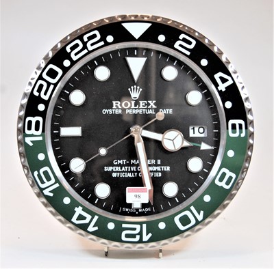 Lot 98 - A modern wall clock, the dial in the form of a...