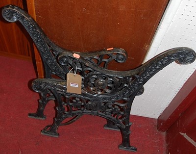 Lot 1098 - A pair of black painted cast iron bench ends,...