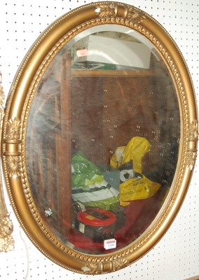 Lot 1106 - A gilt decorated bevelled oval wall mirror, 70...