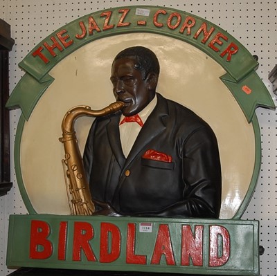 Lot 1114 - A painted and relief carved advertising sign...