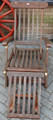 Lot 1134 - A contemporary stained and slatted teak and...