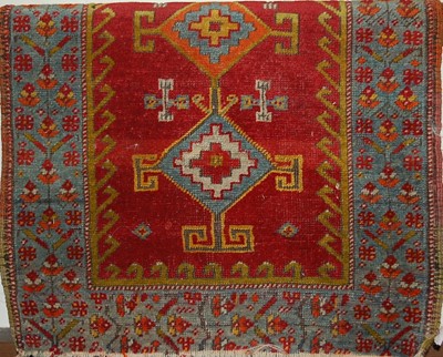 Lot 1153 - A small Persian red ground woollen rug, 80 x 56cm