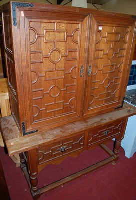 Lot 1171 - A Spanish oak side cupboard, having twin upper...