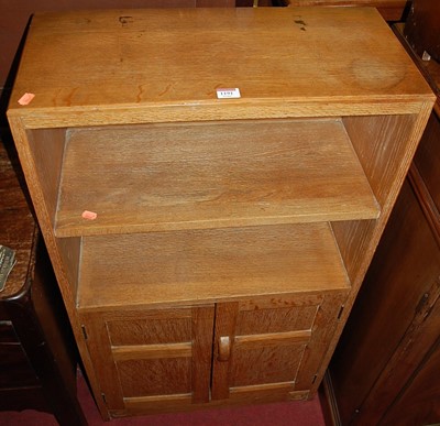 Lot 1191 - A joined and limed oak low bookshelf, having...