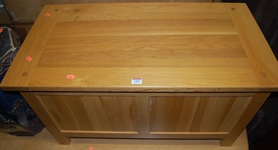 Lot 1202 - A contemporary light oak hinge topped twin...