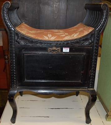 Lot 1209 - A late Victorian ebonised music stool, having...