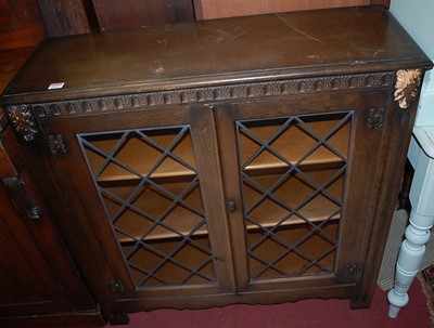 Lot 1237 - A contemporary oak and lead glazed low double...