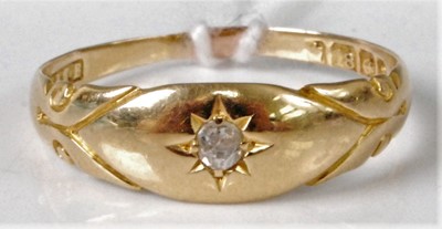 Lot 310 - An 18ct gold diamond solitaire ring, the gypsy...