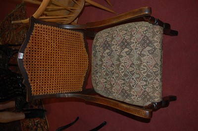 Lot 1281 - An early 20th century oak cane back open arm...