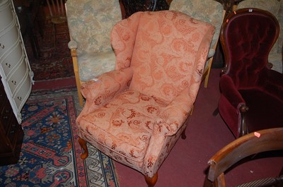 Lot 1286 - A contemporary red floral upholstered wing...