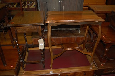 Lot 1321 - An Edwardian walnut shaped topped two-tier...