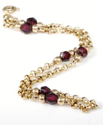 Lot 316 - A lady's 9ct gold and faceted garnet set...