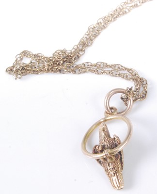Lot 330 - A yellow metal pendant modelled as a parrot...