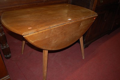 Lot 1346 - A 1960s Ercol light elm drop flap kitchen...