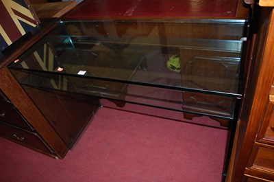 Lot 1351 - A contemporary heavy glass two-tier console...