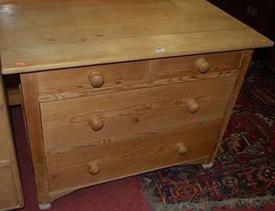 Lot 1255 - A contemporary pine low chest, of two short...