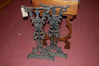 Lot 1357 - A pair of black painted cast iron pub table...