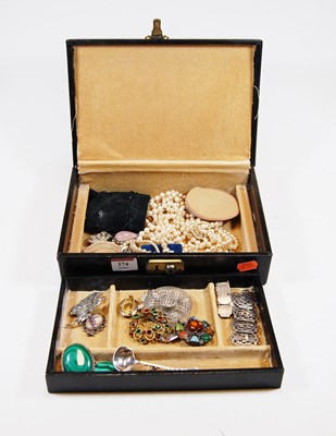 Lot 374 - A leather clad jewellery box and contents to...