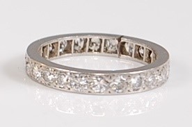 Lot 1272 - A white metal full hoop eternity ring,...
