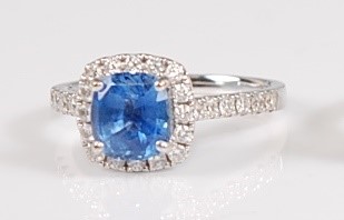 Lot 1268 - A white metal, sapphire and diamond halo...