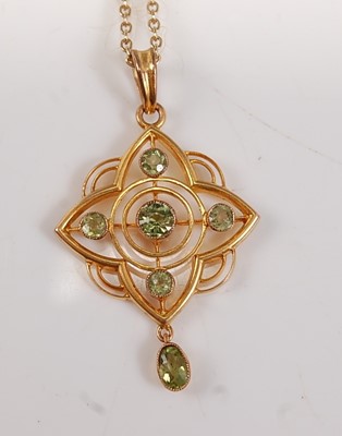 Lot 2643 - A yellow metal peridot quatrefoil pendant,...