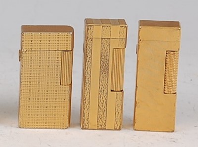 Lot 193 - A collection of three Dunhill gilt metal...
