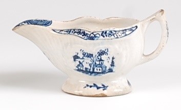 Lot 1043 - A Lowestoft porcelain moulded cream-boat,...
