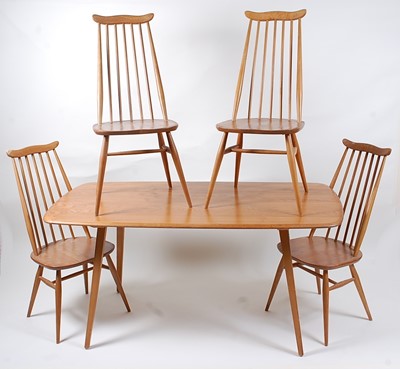 Lot 352 - A 1970s Ercol light elm dining suite,...