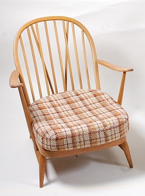 Lot 347 - A 1970s Ercol light elm stickback open lounge...