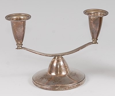 Lot 105 - A 1960s silver squat twin branch candle-holder,...