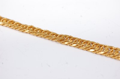 Lot 1212 - A Middle Eastern yellow metal flat and...