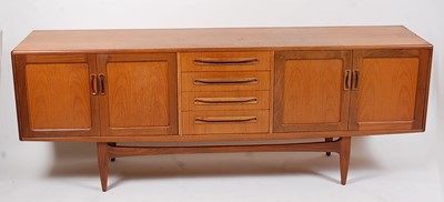 Lot 315 - A 1960s G-Plan teak long sideboard,  the four...