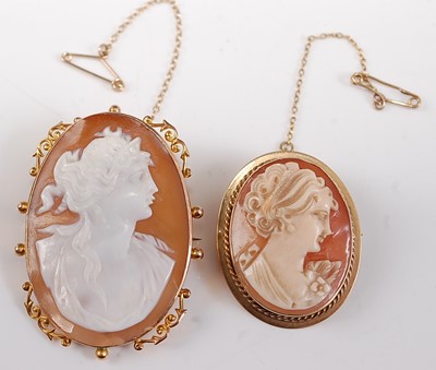Lot 2647 - Two oval carved shell cameo brooches, one with...