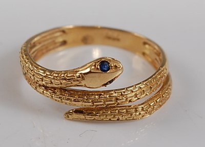 Lot 2650 - A yellow metal snake ring, the head set with...