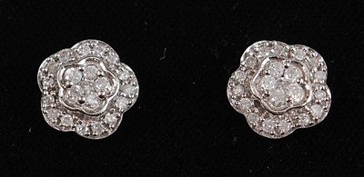 Lot 2658 - A pair of 9ct white gold diamond flower shaped...