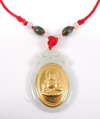 Lot 2534 - A large oval carved white jadeite pendant,...
