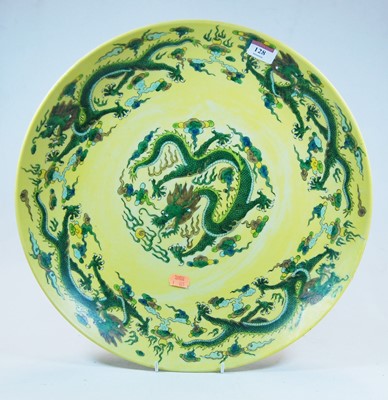 Lot 128 - A Chinese export yellow glazed charger,...