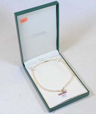 Lot 413 - A cultured pearl pendant on 9ct gold mount, on...