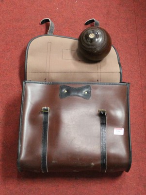 Lot 550 - Four lignum vitae lawn bowls, in faux leather...