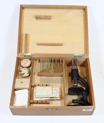 Lot 496 - A student's monocular microscope in fitted...