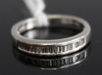 Lot 352 - A platinum and small baguette diamond channel...