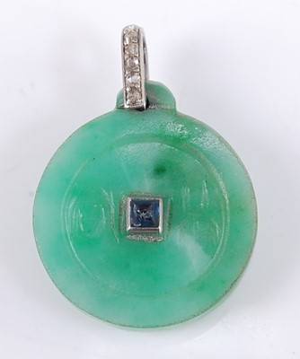 Lot 2563 - An Art Deco jade disc pendant, incised to...