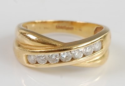 Lot 2690 - An 18ct gold diamond crossover half eternity...