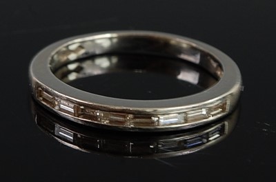 Lot 2692 - A platinum diamond half eternity ring,...