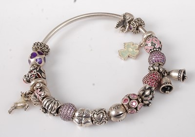 Lot 2736 - A Pandora silver bangle containing various...
