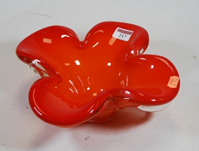 Lot 217 - A large orange tinted glass flower head vase,...