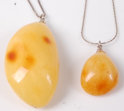 Lot 420 - A yellow amber pendant, of good size, on...