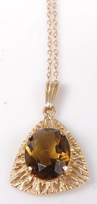 Lot 425 - A modern 9ct gold and smoky topaz set pendant...