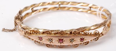 Lot 427 - A 9ct gold bangle, fashioned as twin spiral...