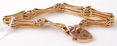 Lot 437 - A 9ct gold gatelink bracelet, with heart...